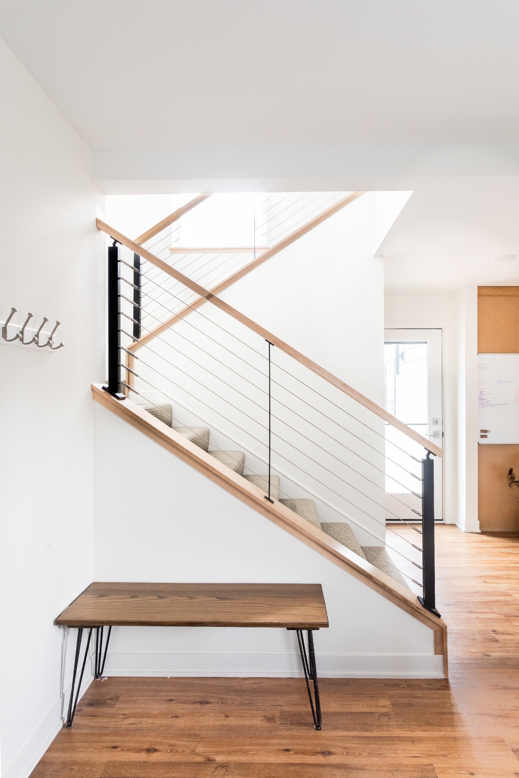 Open stairwell with cable metal and wood natural maple